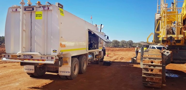 High-capacity Shermac mining service truck delivering fuel and lubricants to heavy equipment on site.