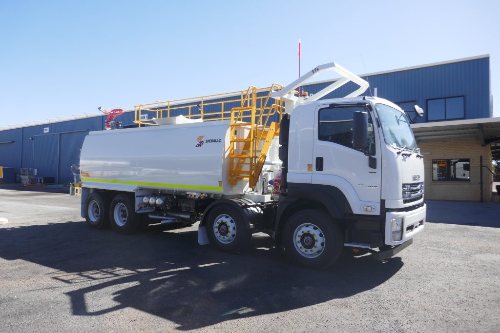 Shermac RS2000 water cart with tall yellow access stairs on Isuzu FVZ at WA factory