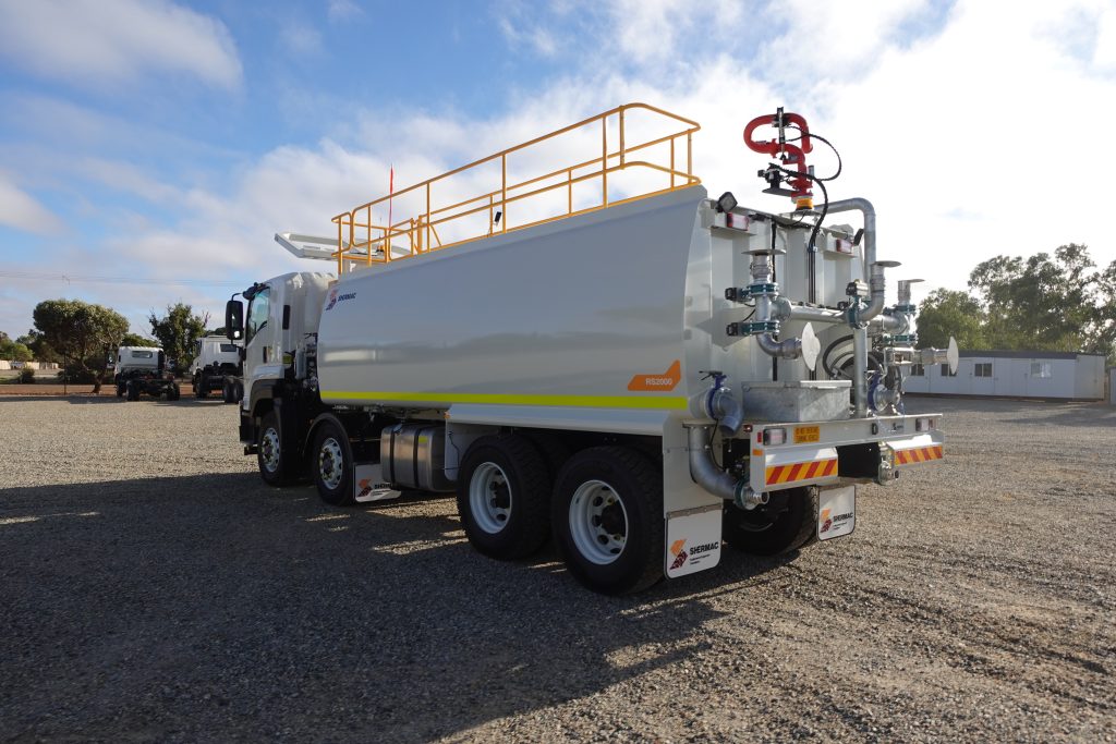 Pump manifold and red spray cannon on the rear of a Shermac RS2000 8x4 water cart in WA