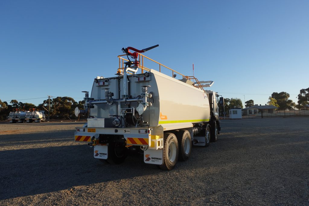 Straight rear of a Shermac RS2000 8x4 water cart, spray cannon and pump manifold at WA yard