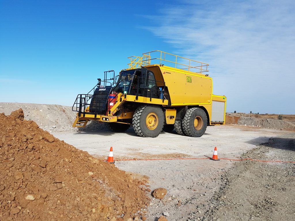 Shermac off-road mine-spec service truck with safety rails, access steps, high-visibility markings and an externally mounted fire extinguisher on site
