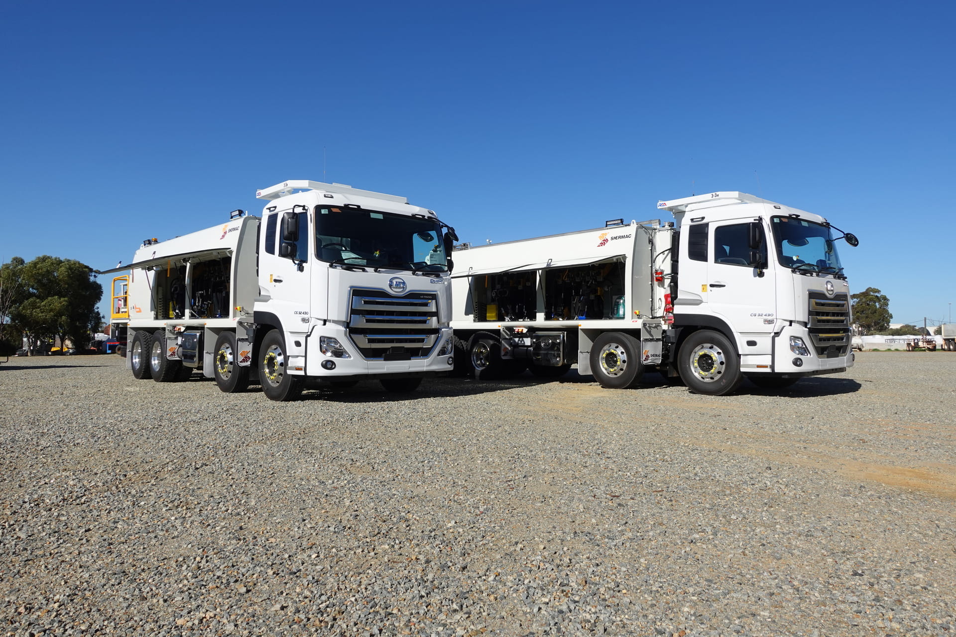 Two Shermac mine-spec service trucks with open lube bodies on WA gravel hardstand