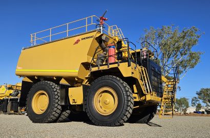 Shermac mine-spec water cart on an Australian mine site, featuring safety railings, high-visibility yellow finish, and heavy-duty off-road tyres