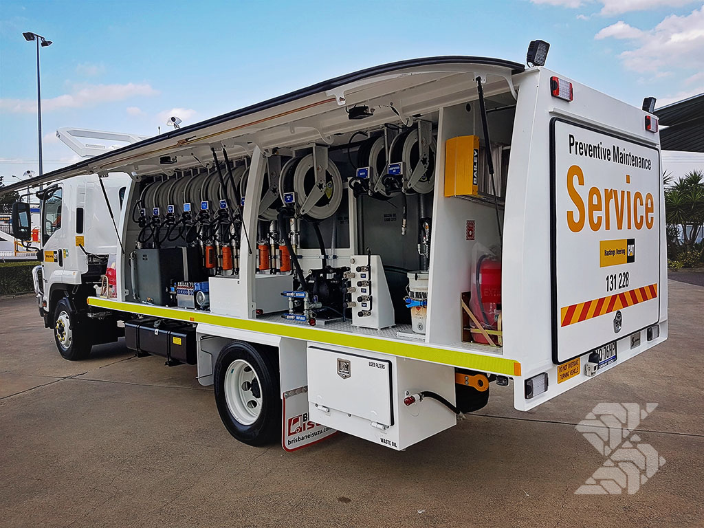 Service truck with open side compartments showing organised hose reels, pumps and maintenance systems for efficient field servicing.