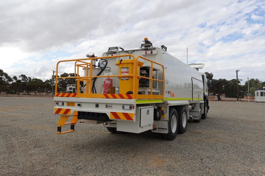 Shermac mine-spec off-road service truck with safety rails, high-visibility markings and fire extinguisher, configured for site-specific compliance.
