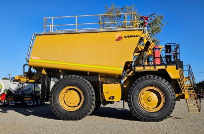 Shermac rigid mine-spec water cart with curved tank design, heavy-duty chassis and elevated safety access platform.
